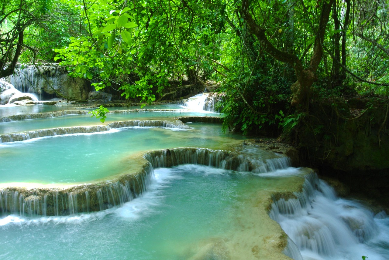The multi-tiered turquoise Kuang Si Falls in the jungle near Luang Prabang, Laos.